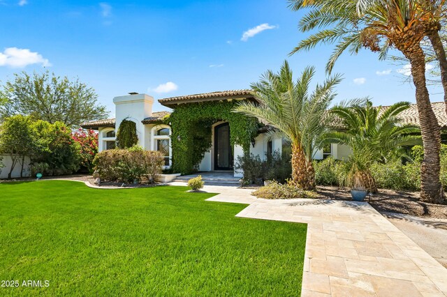 5740 N Casa Blanca Dr, Paradise Valley, AZ 85253 - mediterranean / spanish-style house featuring stucco siding, a tiled roof, and a front lawn