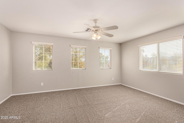 spare room featuring ceiling fan and carpet