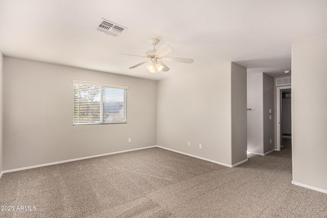 empty room with ceiling fan and dark colored carpet