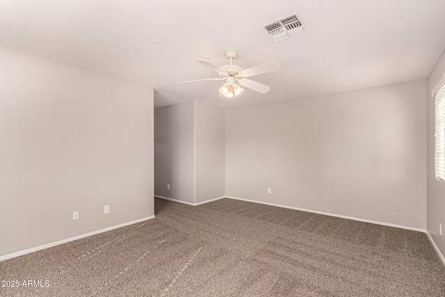 unfurnished room with ceiling fan and carpet