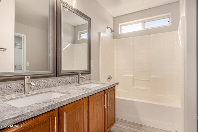 bathroom with vanity, wood-type flooring, and washtub / shower combination