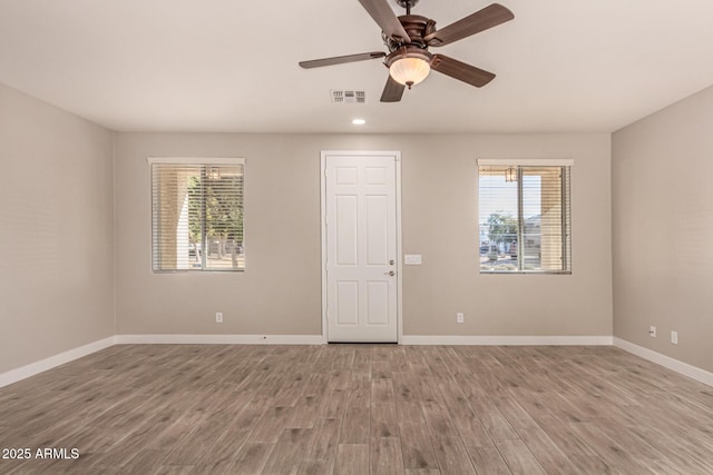 empty room featuring light hardwood / wood-style floors and ceiling fan