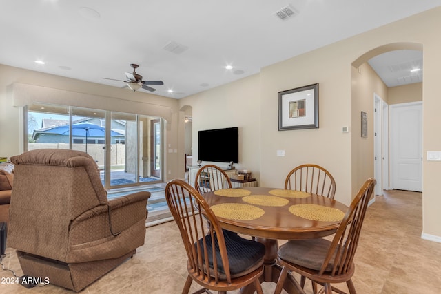 tiled dining space featuring ceiling fan