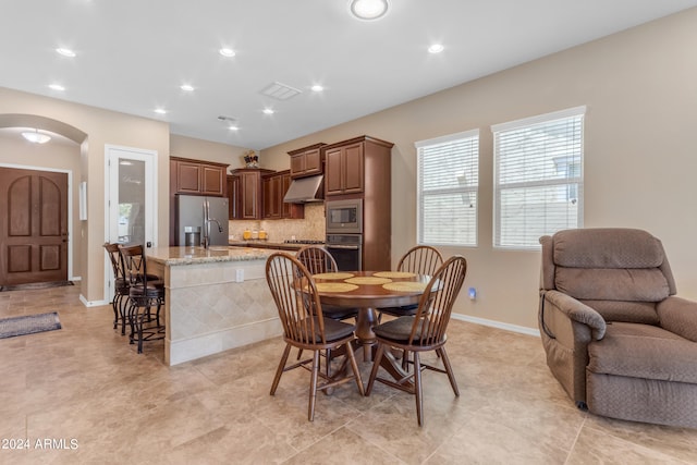 dining room featuring sink and light tile patterned flooring