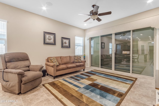 living room featuring light tile patterned floors and ceiling fan