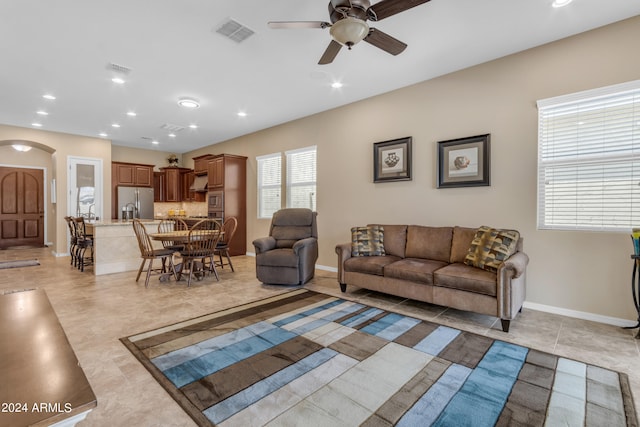 tiled living room featuring ceiling fan