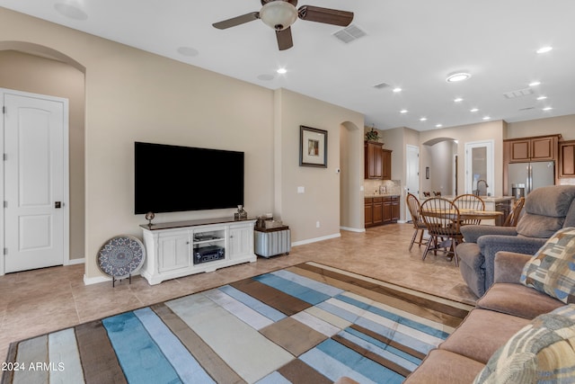 living room with light tile patterned floors and ceiling fan