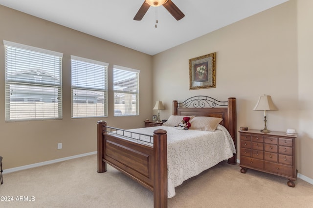 bedroom with ceiling fan and light colored carpet