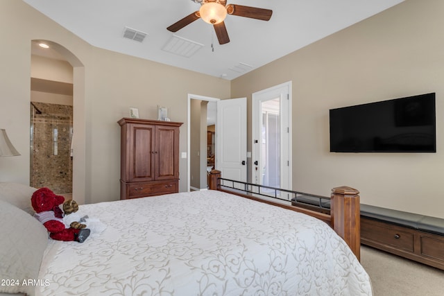 carpeted bedroom featuring ceiling fan and connected bathroom