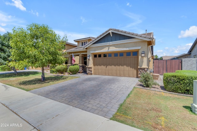 craftsman-style home featuring a garage and a front yard