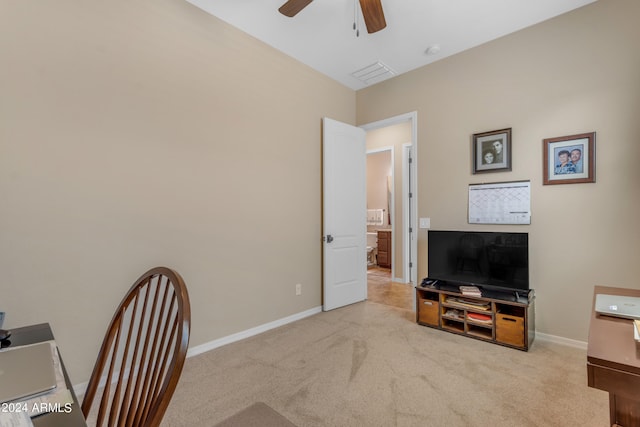 home office featuring light carpet and ceiling fan