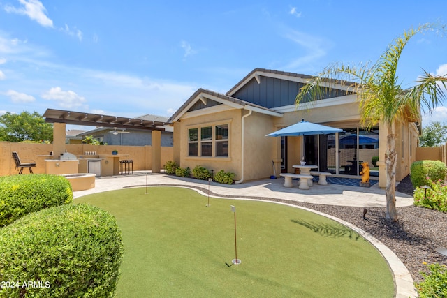 rear view of property with a patio and area for grilling