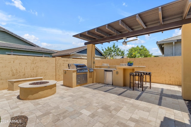 view of patio / terrace with a pergola, an outdoor bar, a fire pit, area for grilling, and an outdoor kitchen