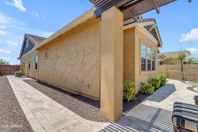 view of home's exterior featuring a pergola and a patio area