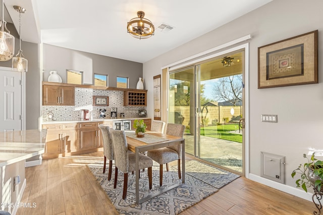 dining area with light hardwood / wood-style floors