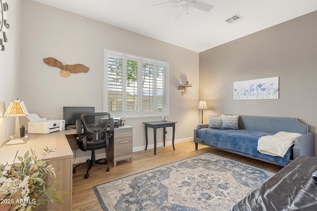 home office with ceiling fan and light hardwood / wood-style floors