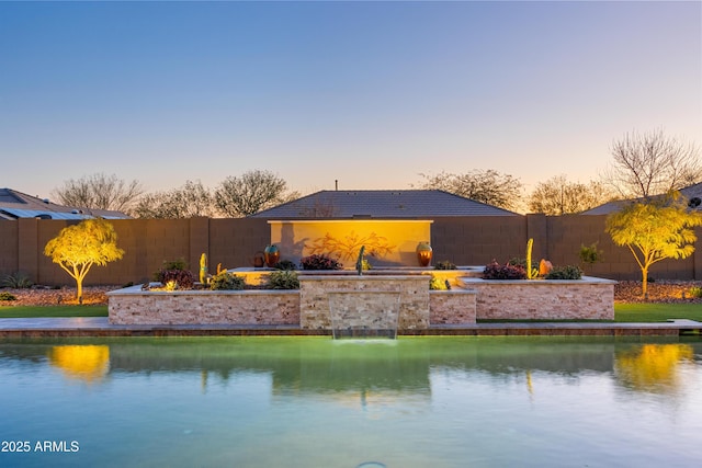 view of pool at dusk