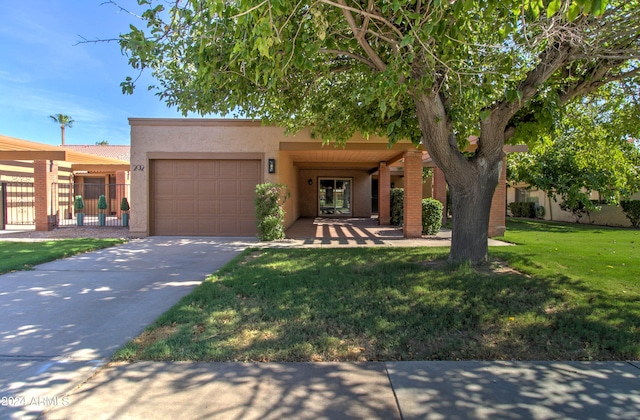 view of front of house featuring a garage and a front yard