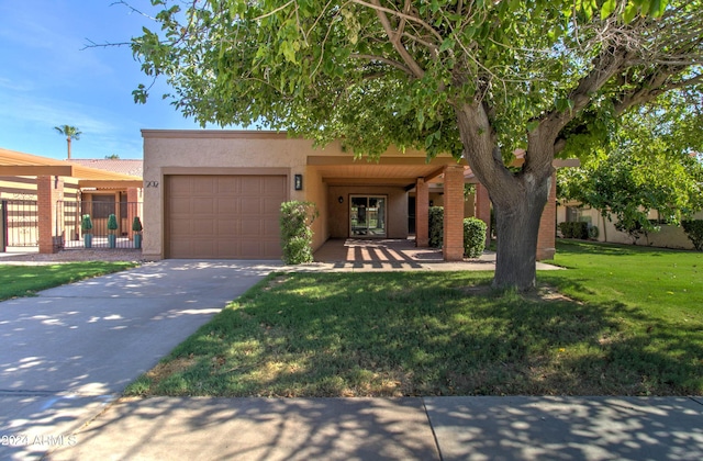 view of front facade with a garage and a front lawn