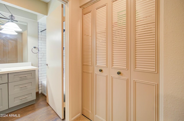 bathroom featuring vanity, hardwood / wood-style floors, and bathing tub / shower combination