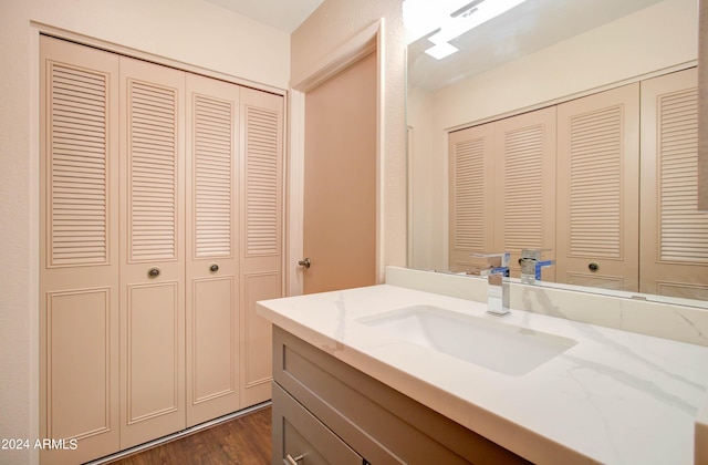 bathroom featuring wood-type flooring and vanity