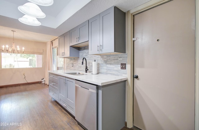 kitchen with stainless steel dishwasher, sink, dark hardwood / wood-style floors, and gray cabinets