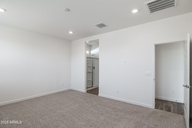 unfurnished room with dark colored carpet