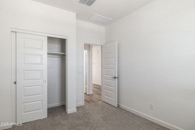 unfurnished bedroom with carpet flooring and a closet