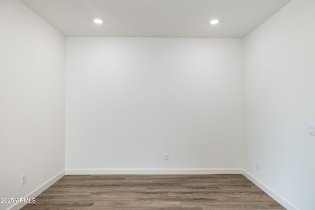 unfurnished room with dark wood-type flooring