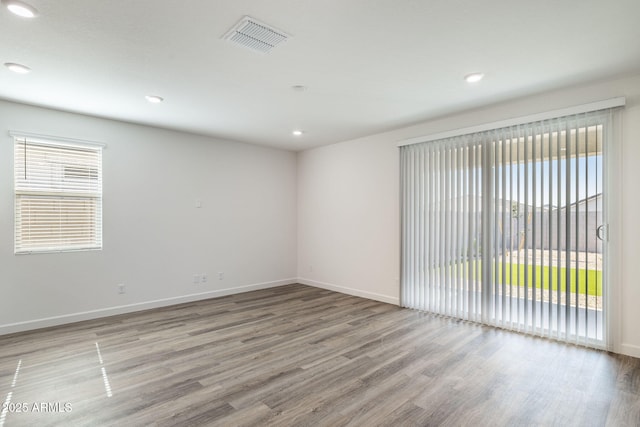 unfurnished room with hardwood / wood-style floors