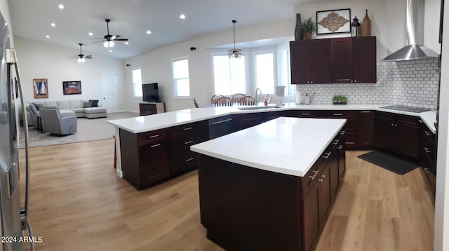 2060 E Quartz St, Mesa, AZ 85213 - kitchen featuring wall chimney range hood, a sink, black electric cooktop, light wood-style flooring, and a peninsula
