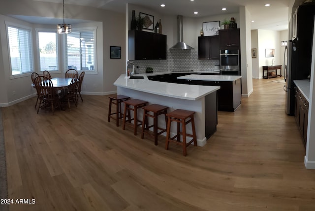 2060 E Quartz St, Mesa, AZ 85213 - kitchen featuring wall chimney range hood, a sink, baseboards, stainless steel appliances, and light wood finished floors