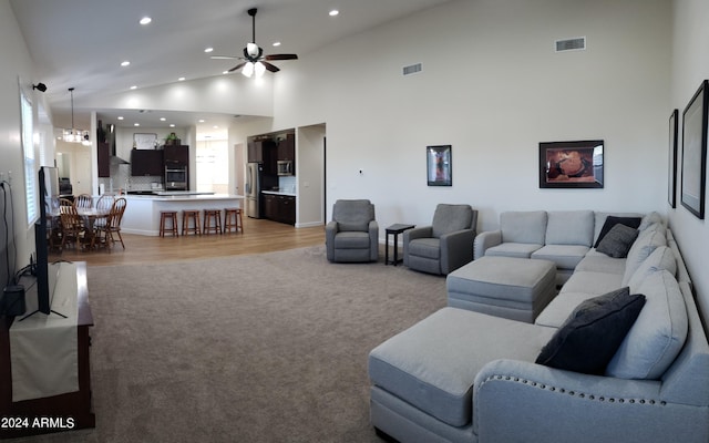 2060 E Quartz St, Mesa, AZ 85213 - living room with a ceiling fan, recessed lighting, light wood-style floors, light carpet, and high vaulted ceiling