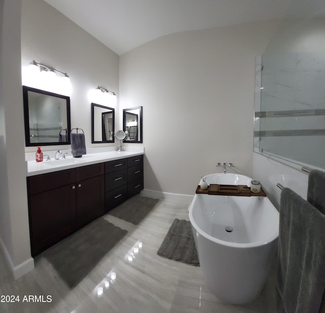 2060 E Quartz St, Mesa, AZ 85213 - bathroom with a freestanding tub, double vanity, baseboards, and lofted ceiling