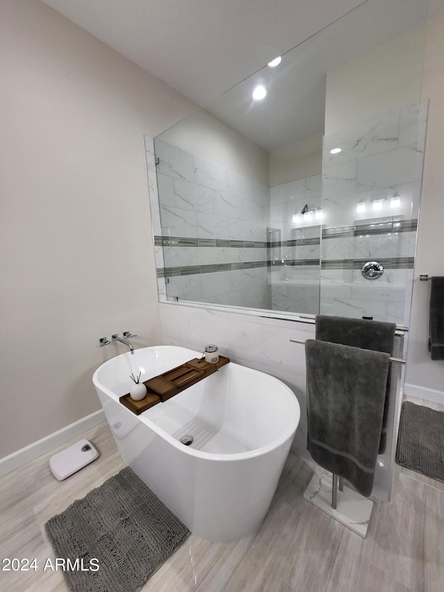 2060 E Quartz St, Mesa, AZ 85213 - full bath with a freestanding tub, walk in shower, wood finished floors, tile walls, and baseboards