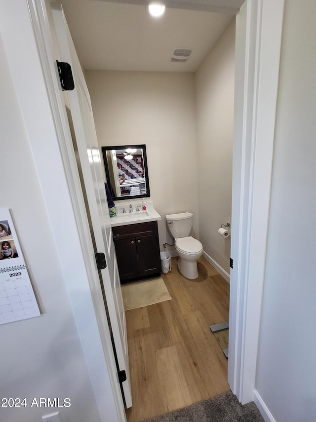 2060 E Quartz St, Mesa, AZ 85213 - half bath with vanity, toilet, wood finished floors, and baseboards