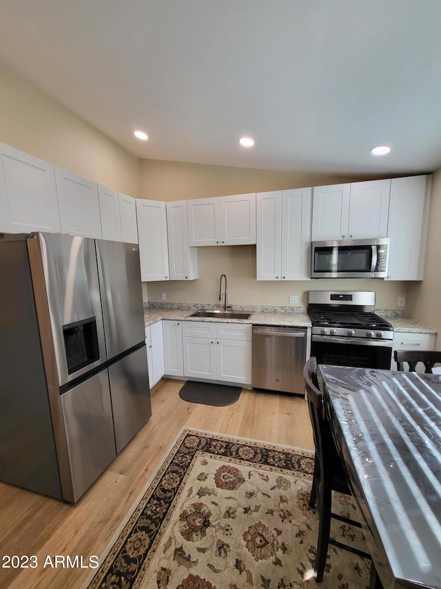 2060 E Quartz St, Mesa, AZ 85213 - kitchen with stainless steel appliances, a sink, light wood-style floors, recessed lighting, and white cabinets