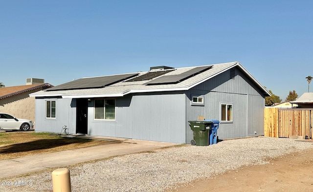 exterior space with solar panels and fence