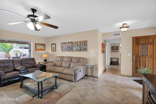 living area featuring visible vents, baseboards, and ceiling fan