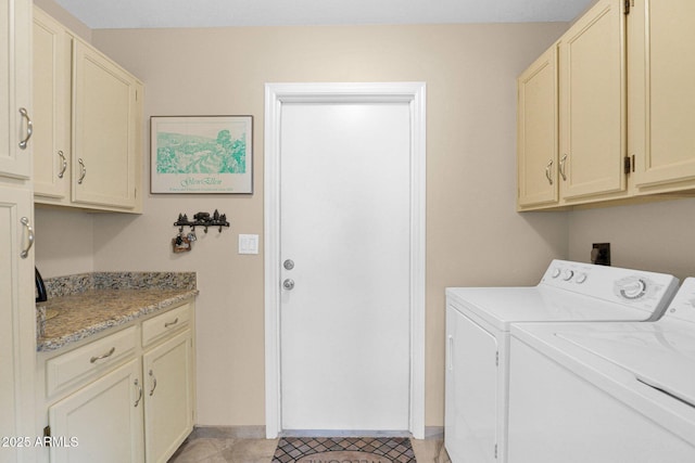 laundry area with light tile patterned floors, cabinet space, independent washer and dryer, and baseboards