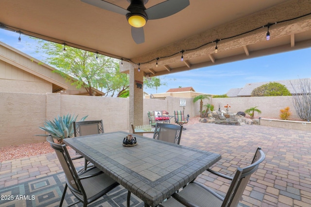 view of patio featuring ceiling fan, a fenced backyard, and outdoor dining space