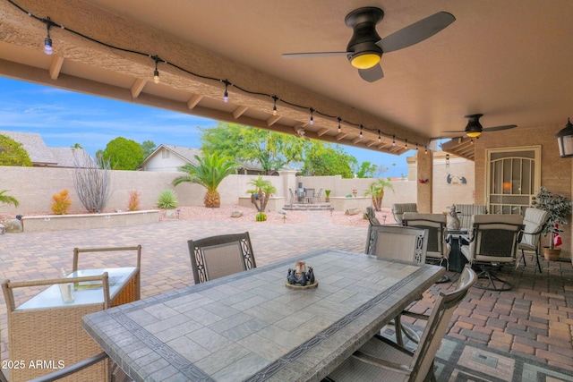 view of patio / terrace featuring outdoor dining area, a fenced backyard, and ceiling fan