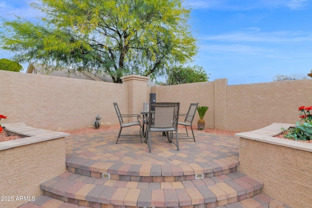 view of patio featuring outdoor dining area and a fenced backyard