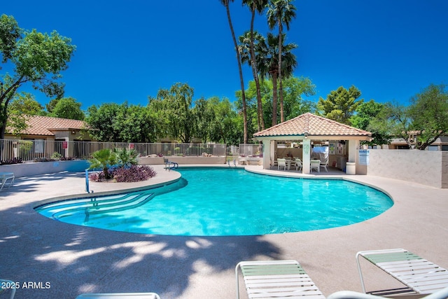 pool featuring a gazebo, a patio area, and fence