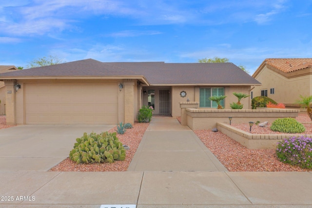 single story home with concrete driveway, a garage, and stucco siding