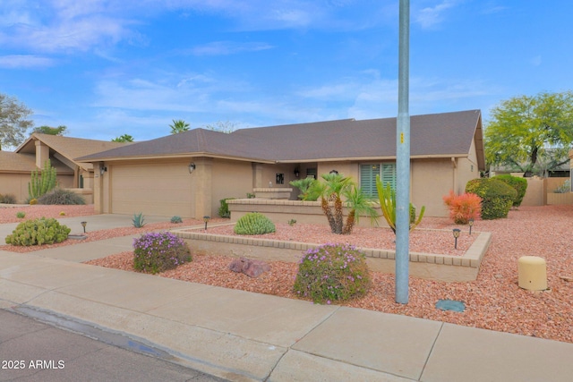 view of front of home featuring concrete driveway, a garage, and stucco siding