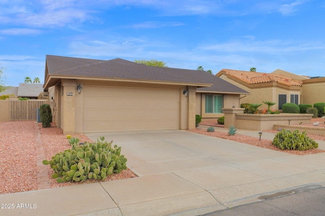 view of front of home featuring concrete driveway, fence, a garage, and stucco siding