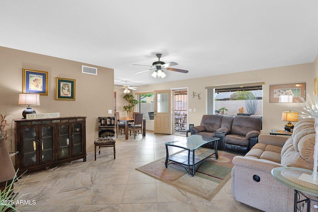 living room with visible vents and ceiling fan