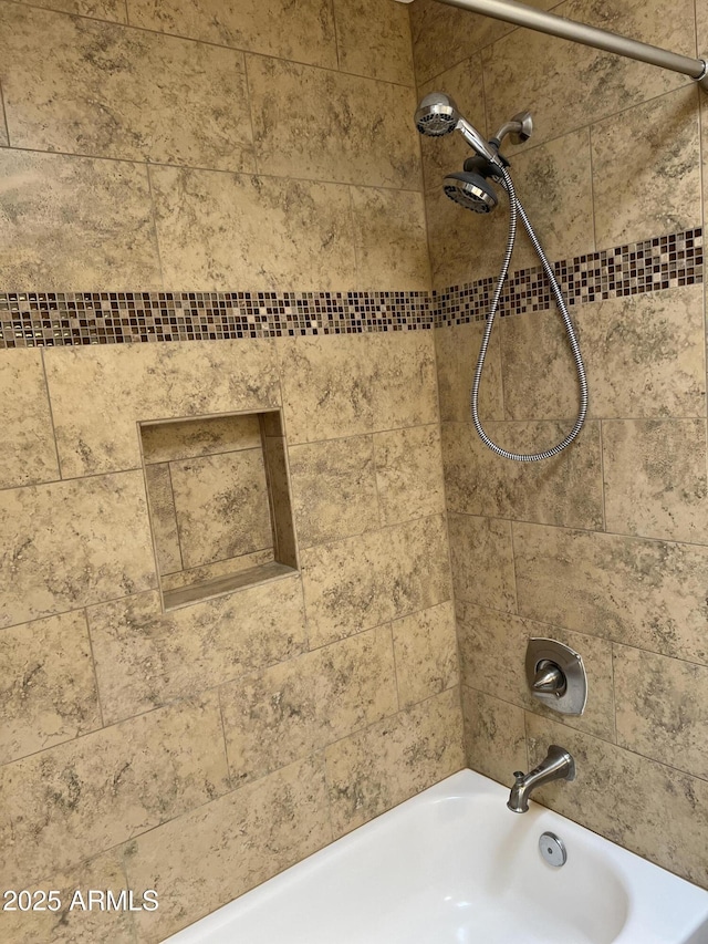 room details featuring shower / bath combination