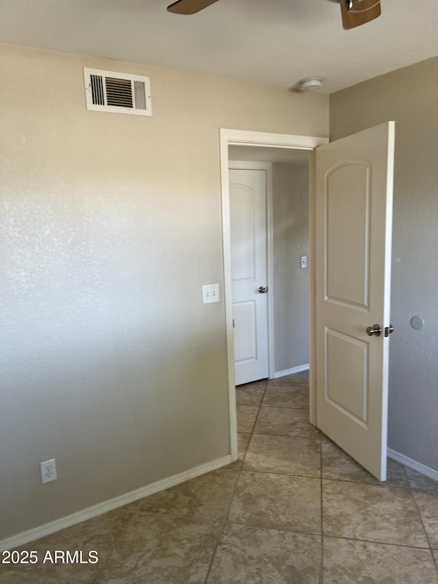 hallway featuring visible vents and baseboards